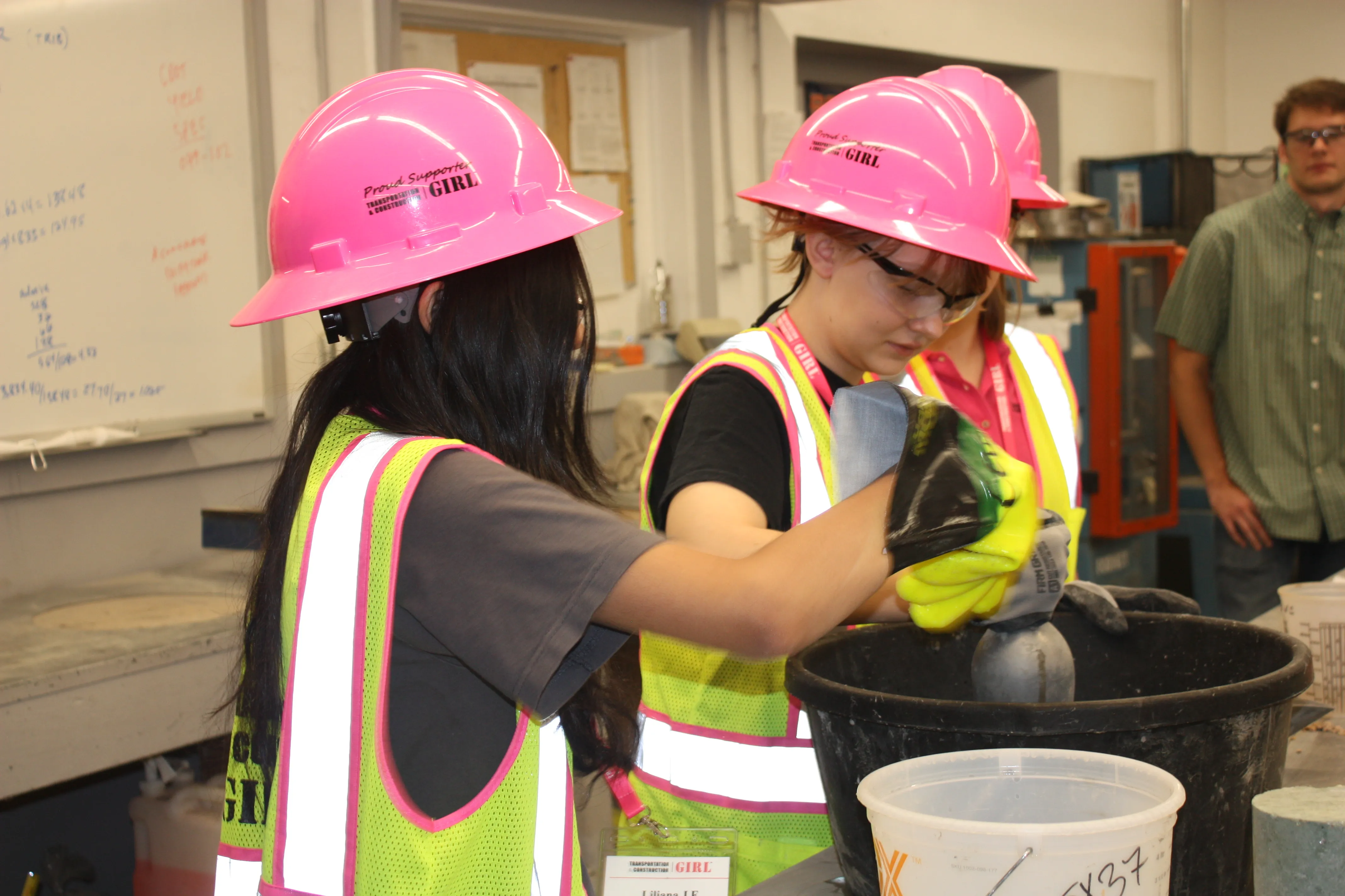 girls at Career Week mixing concrete in little buckets